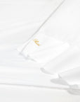 Angel Luxe in white sheet texture shot.