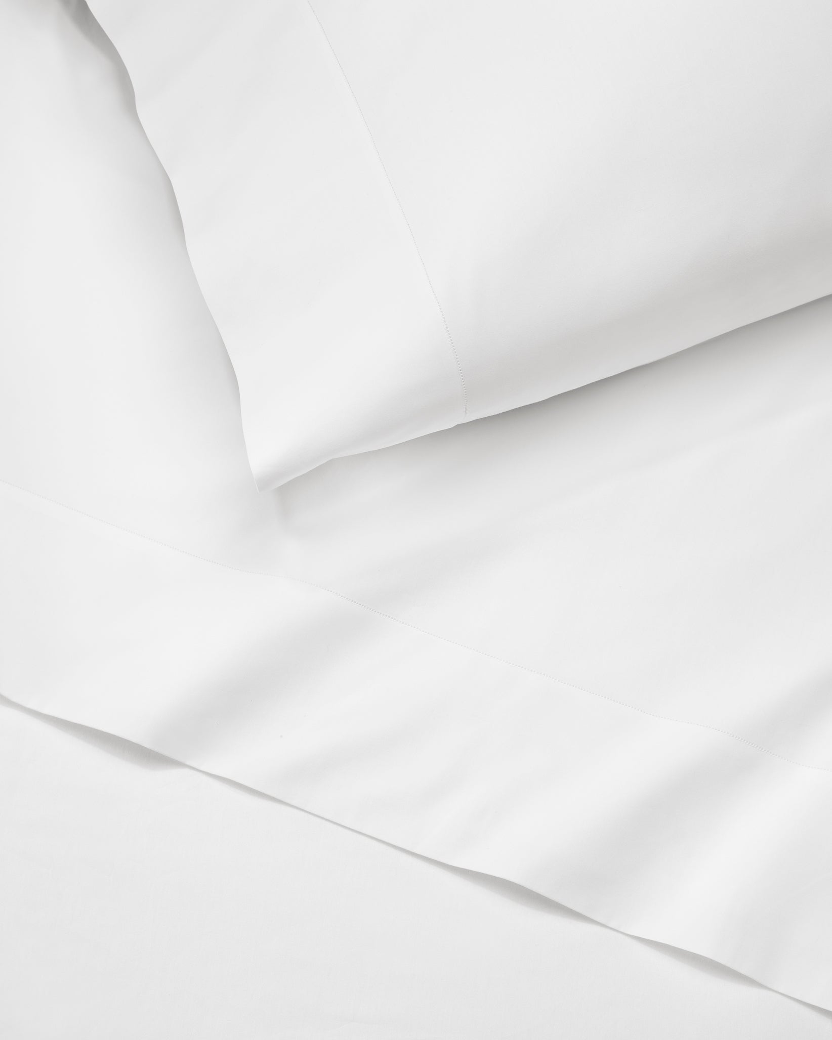 Angel Luxe in white pillowcase and flat sheet.