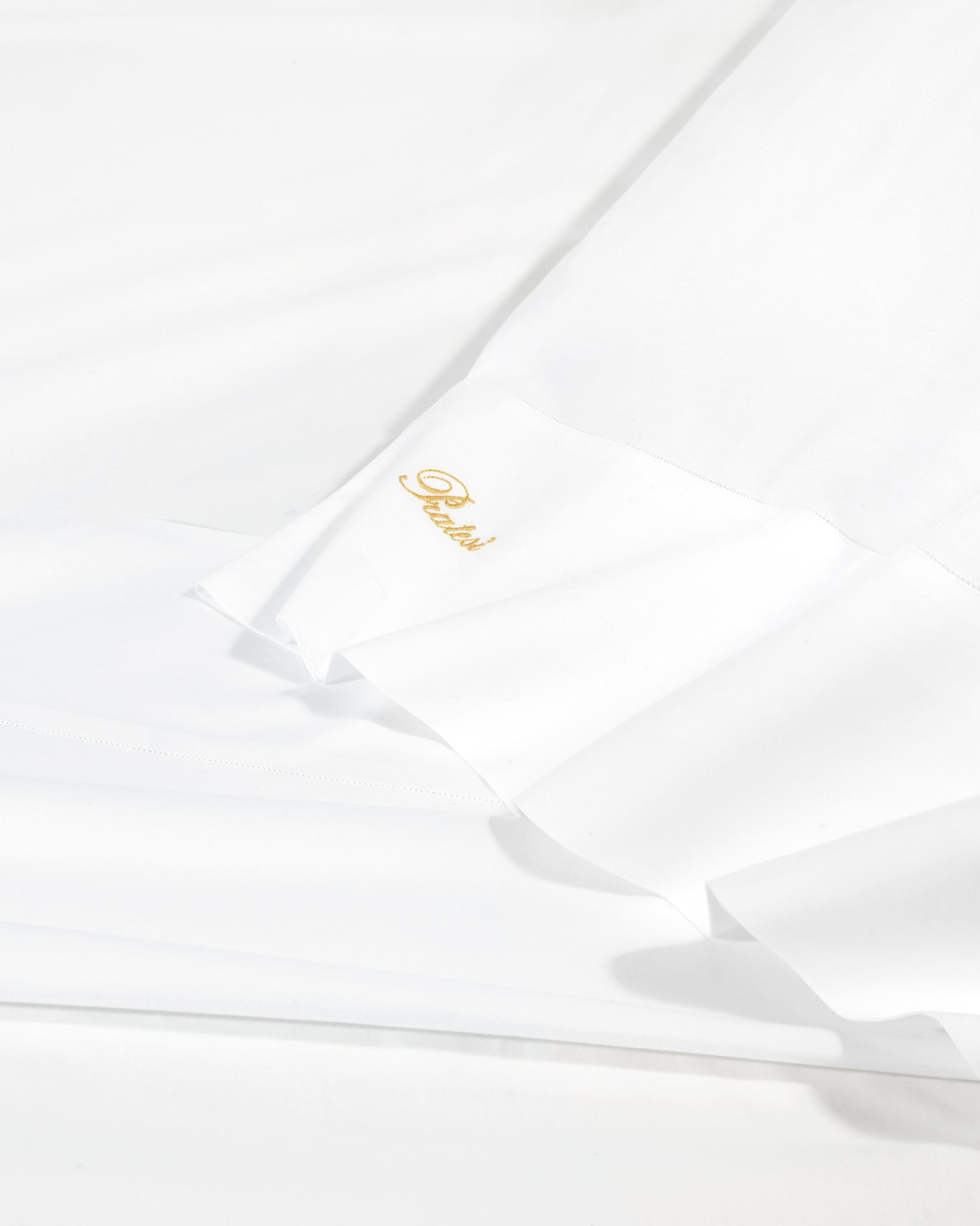 Angel Luxe in white sheet texture shot.