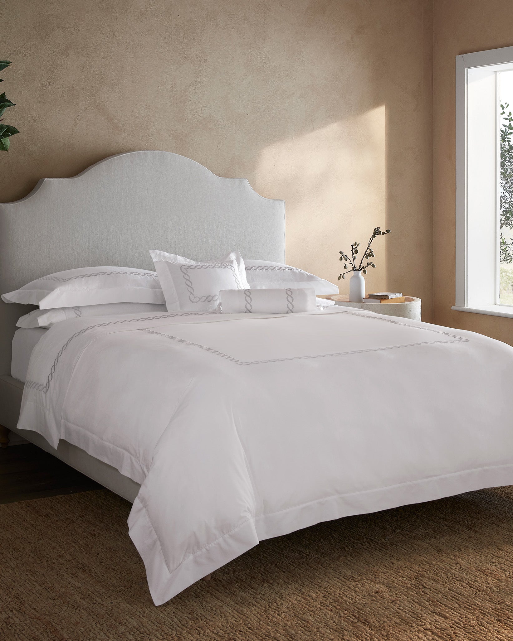 Treccia Moderno white/sterling bed fully made side angle.